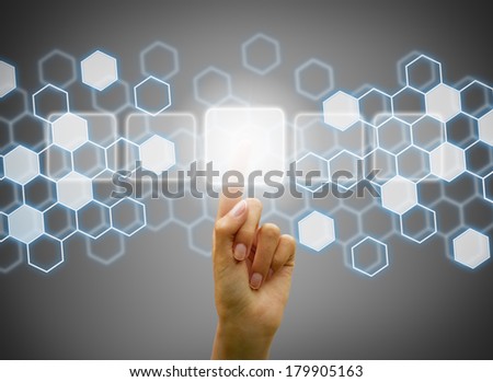 Woman hand touching digital interface on a technological background