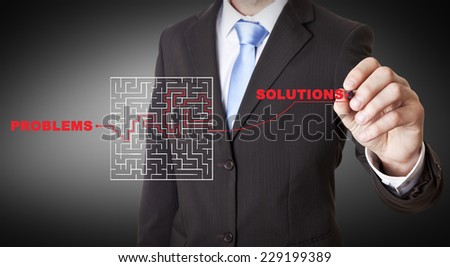 Businessman drawing a maze on a digital screen