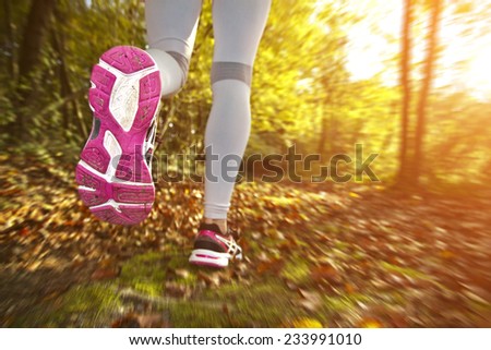 Fitness Girl running at sunset in forest