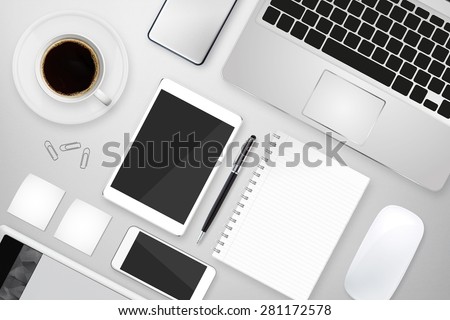 Workplace with tablet computer and mobile phone on table
