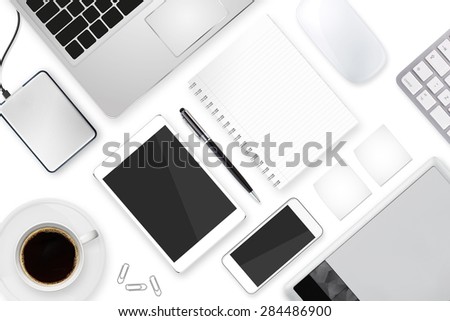 Workplace with tablet computer and mobile phone on table
