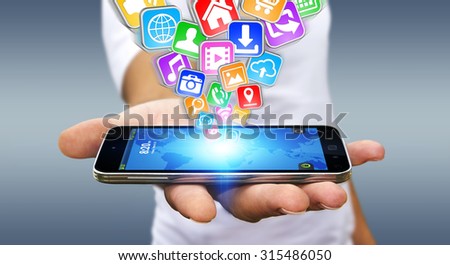 Businessman with modern mobile phone in his hand and applications flying over