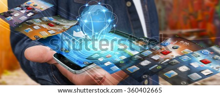 Businessman with modern mobile phone in his hand switching pictures
