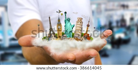 Young man holding a cloud full of famous monuments of the world in his hands