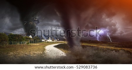 View of a large tornados destroying the landscape and city