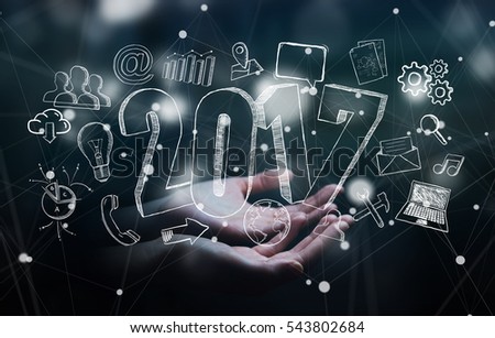Businessman holding 2017 hand drawn text in his hand