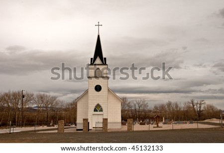 a small country church and cemetery in the mountains of Montana