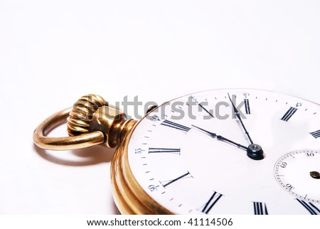 Ancient pocket watch close up on a white background