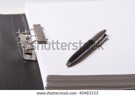 pen on file folder with paper for office