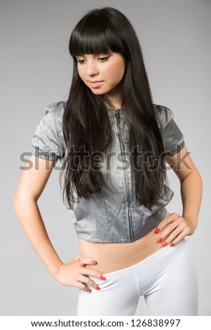 attractive young woman with black hair and white leggings