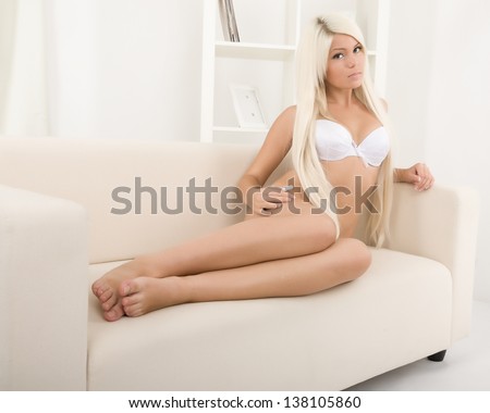 Beautiful Blonde In Lingerie On The Couch Stock Photo