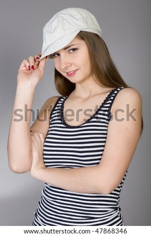 beautiful girl in a striped blouse and a white cap