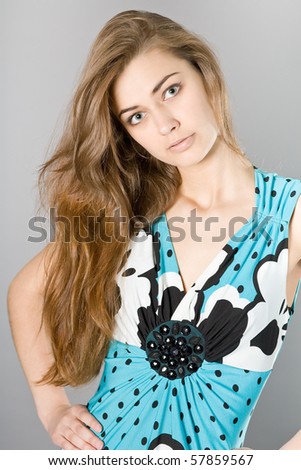 Portrait of the young beautiful girl in elegant clothes