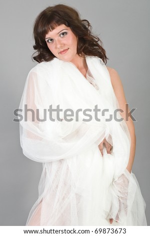 The young attractive girl in a white cape