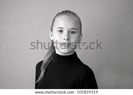 A beautiful blond-haired 13-years old girl, portrait in black and white