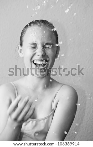 Beautiful wet woman face with water drop. Close-up portrait in black and white