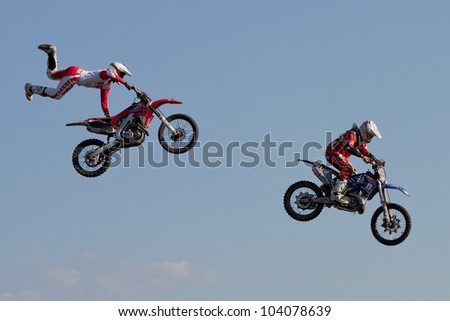 GALWAY, IRELAND - MAY 26:  J. Grindrod and D. Wiggins freestyle motocross riders jumps through the air during The  Extreme Stunt Show on May 26, 2012 in Galway, Ireland