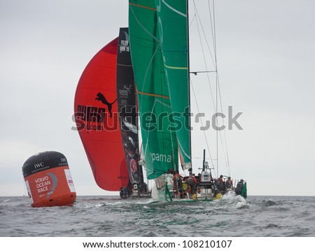 GALWAY, IRELAND - JULY 7: PUMA Ocean Racing  and Groupama Sailing Team, passing the mark in the Discover Ireland In-Port Race, during the Volvo Ocean Race 2011-12, on July 7, 2012 in Galway, Ireland.
