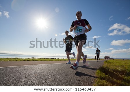 GALWAY, IRELAND - OCTOBER 6: Mark Breen (1742) and other athletes compete during annual Galway Bay Half Marathon and 10K, on October 6, 2012 in Galway, Ireland.