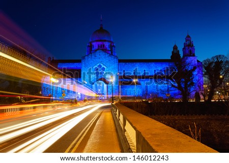 Galway Cathedral lit up blue at night and car lights trails