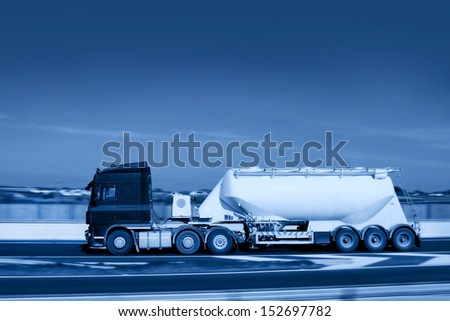 Truck With Limestone Flour Tank in motion on the road