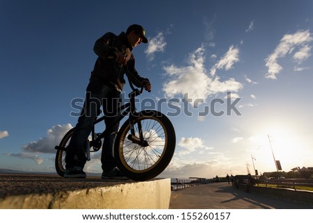 Young man with bicycle prepare to stunts at the street