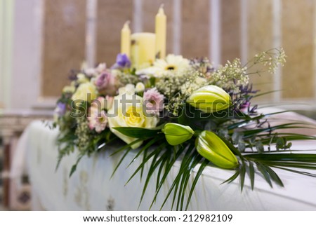 Close up of Wedding flowers set up in catholic church.