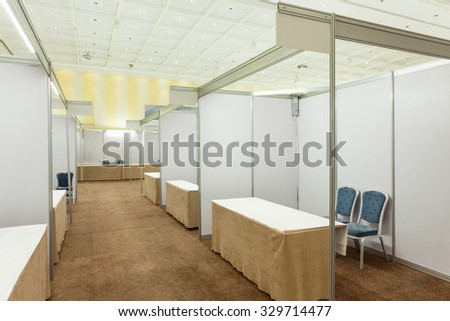 Trade show interior with booth and tables