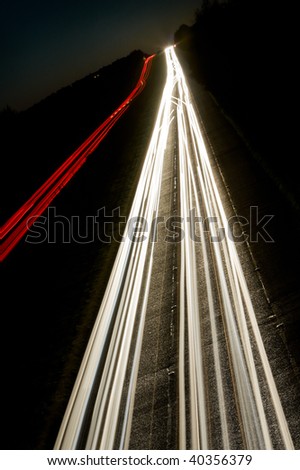 car lights trails on the busy highway in the deep dusk