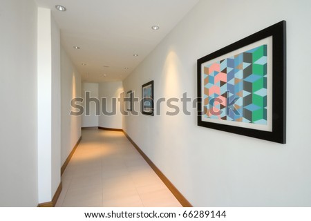 Corridor interior with white walls and pictures