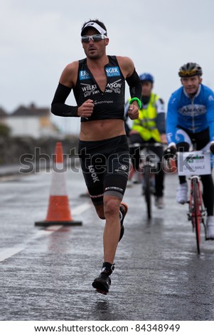 GALWAY, IRELAND - SEPT 4: Mike Aigroz (9), winner, competes at first Edition of Galway Iron Man  Triathlon on September 4, 2011 in Galway, Ireland