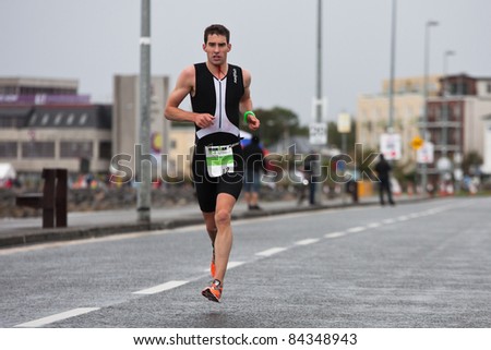 GALWAY, IRELAND - SEPT 4: Owen Cummins (12) , III place, competes at first Edition of Galway Iron Man Triathlon on September 4, 2011 in Galway, Ireland
