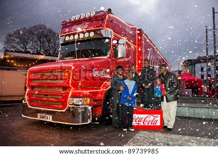 GALWAY - NOVEMBER 27: unidentified family posing with Coca-Cola Christmas truck at \'Holidays are coming\' advert at Annual Galway Continental Christmas Market on November 27, 2011 in Galway, Ireland.