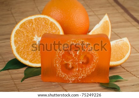 Natural orange soap manual manufactures against juicy fresh fruits of an orange