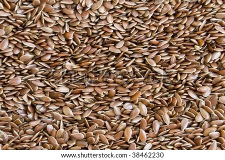 Linseed - view from the top. Lots of brown little seeds.  It can be used for cooking, ex. as a additional ingredient for bread. It\'s also used in medicine - can help with stomach problems.
