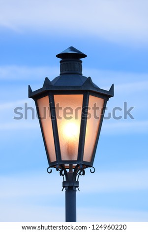 Lantern glowing in morning twilight, San Marino (Italy)