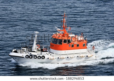 NORWAY - AUGUST 08, 2010: Pilot boat races in the North Sea to allow the passage of a cruise ship on a complex route segment