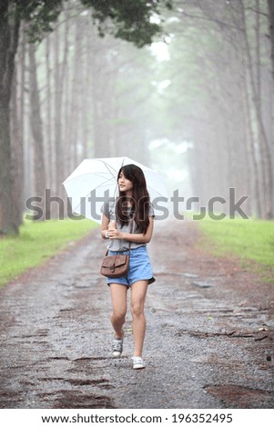 Girl on the rain in pine forest