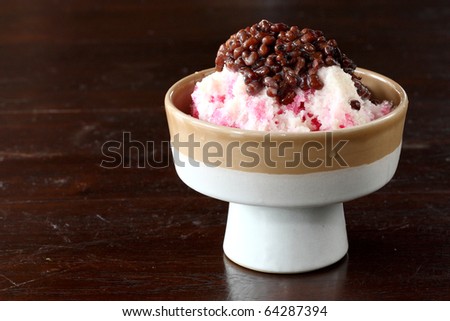 Traditional Japanese Dessert , A Bowl of Red Bean Sweet with red ice on wood pattern
