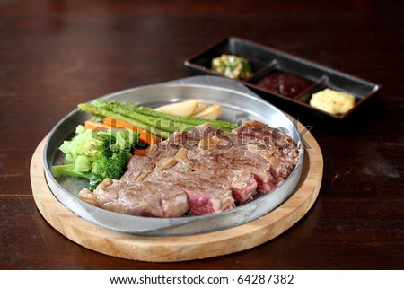 japanese food beef steak and sauce with dark brown wood pattern