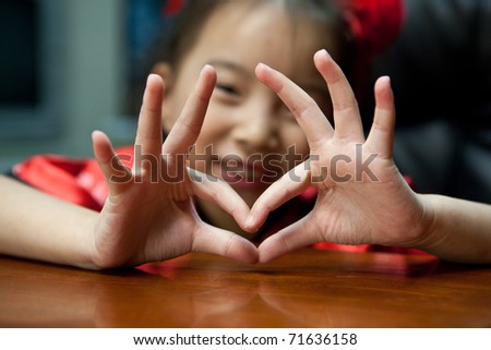 stock photo cute lovely sweet asian kid girl with love symbol in home