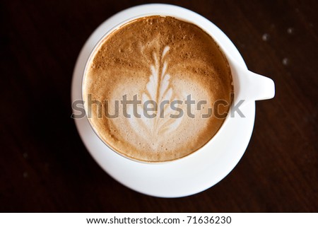 cappuccino coffee with wood background