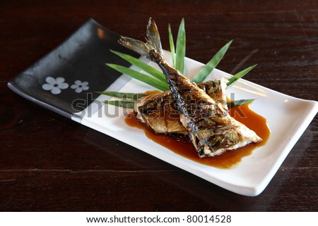 Grill fish with sauce , Saba fish teriyaki sauce  japanese food with dark brown wood pattern