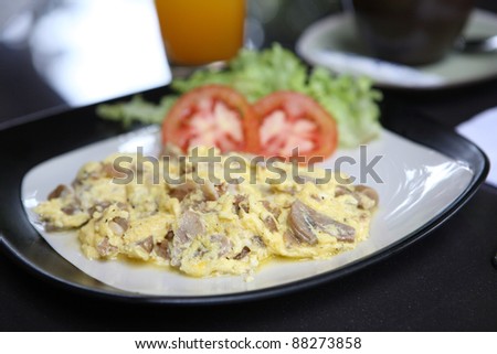 Omelette with mushroom and bacon , orange juice and coffee for background