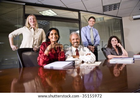Multi-ethnic group of office workers in boardroom