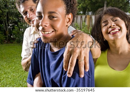 Teenage boy with proud parents