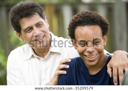 Hispanic father with African American teenage son