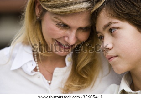 Close-up portrait of mother and son gazing at one another