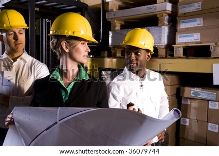 Workers with female boss in storage warehouse