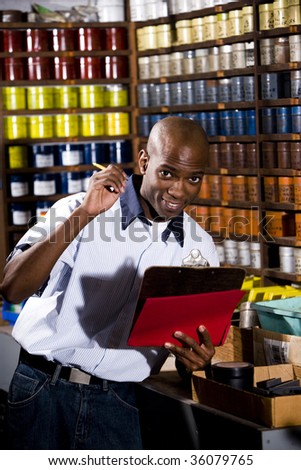 Man standing in front of colored inks in print shop